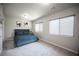 This bedroom has a bed, carpet and two windows with blinds to let sunlight in at 9807 Panther Hollow St, Las Vegas, NV 89141