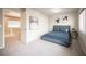 Comfortable bedroom with a blue bed, closet space, and bright natural light at 9807 Panther Hollow St, Las Vegas, NV 89141