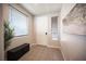 Welcoming entryway featuring tile flooring, a storage bench, and natural light from the windows at 9807 Panther Hollow St, Las Vegas, NV 89141
