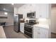 Kitchen features stainless steel appliances and white cabinets at 9807 Panther Hollow St, Las Vegas, NV 89141