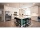 Bright kitchen features a large island with seating, stainless steel appliances, and ample white cabinetry at 9807 Panther Hollow St, Las Vegas, NV 89141