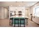 Spacious kitchen boasts an island with barstool seating, stainless steel appliances, and modern lighting at 9807 Panther Hollow St, Las Vegas, NV 89141