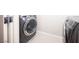 Laundry room with modern, gray front load washer and dryer, plus tile flooring at 9807 Panther Hollow St, Las Vegas, NV 89141