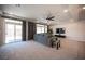 Bright living room boasts a comfortable gray sofa, sliding glass doors, and backyard access at 9807 Panther Hollow St, Las Vegas, NV 89141