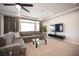 Cozy living room showcases a gray sectional sofa, modern decor, and natural light at 9807 Panther Hollow St, Las Vegas, NV 89141