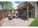 Outdoor patio with a fire pit, comfortable seating, pavers, and a ceiling fan at 9807 Panther Hollow St, Las Vegas, NV 89141