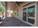 Covered patio with a ceiling fan, sliding glass doors and comfortable outdoor seating at 9807 Panther Hollow St, Las Vegas, NV 89141