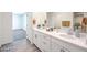 Bright bathroom featuring a double sink vanity, white cabinets and modern finishes at 1027 Gentle Swan St # 689, Henderson, NV 89011