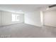 Spacious bedroom with neutral carpet, white walls, recessed lighting, and a large window at 1027 Gentle Swan St # 689, Henderson, NV 89011