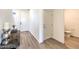 Clean entryway featuring wood-look floors, white walls, and a half bathroom at 1027 Gentle Swan St # 689, Henderson, NV 89011