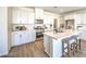 Modern kitchen with white cabinets, stainless steel appliances, quartz countertops and island with seating at 1027 Gentle Swan St # 689, Henderson, NV 89011