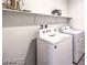 Modern laundry room featuring a washing machine and dryer with a shelf above at 1027 Gentle Swan St # 689, Henderson, NV 89011