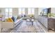 Bright and airy living room with neutral decor, large windows, and stylish furniture at 1027 Gentle Swan St # 689, Henderson, NV 89011