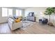 Open-concept living room with hardwood floors, modern furniture, and lots of natural light at 1027 Gentle Swan St # 689, Henderson, NV 89011