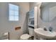 A well-lit half bath features a pedestal sink, and decorative accents at 10373 Perfect Parsley St, Las Vegas, NV 89183