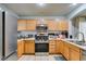 Well-equipped kitchen with stainless steel appliances, wooden cabinets, and modern fixtures at 10373 Perfect Parsley St, Las Vegas, NV 89183