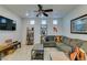 Well-lit living room with a sectional sofa, stylish accents, and entertainment setup at 10373 Perfect Parsley St, Las Vegas, NV 89183