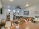 Cozy living room area with a large sectional sofa and a ceiling fan at 10373 Perfect Parsley St, Las Vegas, NV 89183