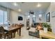 Bright living room featuring a dining area, plush sofa, and ample natural light at 10373 Perfect Parsley St, Las Vegas, NV 89183