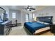 Well-lit main bedroom with a ceiling fan, dark dresser, and exterior door at 10373 Perfect Parsley St, Las Vegas, NV 89183
