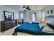 Spacious main bedroom with a ceiling fan, dark dresser, and a door to the exterior at 10373 Perfect Parsley St, Las Vegas, NV 89183