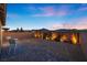 Cozy backyard featuring desert landscaping with landscape lighting, privacy wall, and patio at 10431 Seelos St, Las Vegas, NV 89178