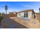 Backyard features a small patio with chairs, desert-friendly landscaping, and easy access to the house at 10431 Seelos St, Las Vegas, NV 89178