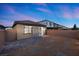 Backyard featuring a small patio with chairs, desert-friendly landscaping, and easy access to the house at 10431 Seelos St, Las Vegas, NV 89178