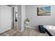 Neutral bedroom featuring wood-look floors, beachy decor, and a hallway leading to another room at 10431 Seelos St, Las Vegas, NV 89178