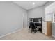 Bedroom featuring gray walls, neutral carpet, computer desk, and a window with blinds at 10431 Seelos St, Las Vegas, NV 89178
