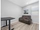 Bonus room featuring wood-look flooring, a sleeper sofa, and a small table at 10431 Seelos St, Las Vegas, NV 89178