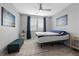 Well-lit bedroom with a ceiling fan, modern decor, and ample natural light at 10431 Seelos St, Las Vegas, NV 89178