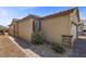 Exterior angle of home showcasing desert landscaping, walkway, and neutral tones at 10431 Seelos St, Las Vegas, NV 89178