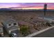 Charming two-story home featuring desert landscaping, a paver driveway, and a backdrop of scenic mountains at sunset at 10431 Seelos St, Las Vegas, NV 89178