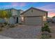Charming two-story home featuring desert landscaping, a brick driveway, and a neutral color palette at 10431 Seelos St, Las Vegas, NV 89178