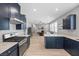 Open-concept kitchen with stainless steel appliances seamlessly connected to the living area at 10431 Seelos St, Las Vegas, NV 89178
