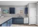 Functional kitchen with navy cabinets and stainless steel appliances, plus easy access to the entryway at 10431 Seelos St, Las Vegas, NV 89178