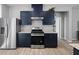 Well-equipped kitchen with stainless steel appliances and sleek navy cabinets at 10431 Seelos St, Las Vegas, NV 89178