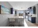 Modern kitchen featuring navy cabinets, stainless steel appliances, and breakfast bar seating at 10431 Seelos St, Las Vegas, NV 89178