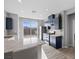 Bright kitchen with stainless steel appliances, navy cabinets, and sliding glass doors to the outside at 10431 Seelos St, Las Vegas, NV 89178