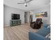 Comfortable living room with beach-themed wall art, wood-look flooring, and contemporary furniture at 10431 Seelos St, Las Vegas, NV 89178