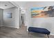 Entry area with gray walls, beach artwork, wood-look flooring, and minimal stylish furniture at 10431 Seelos St, Las Vegas, NV 89178
