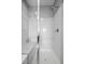 Bright shower with glass door, chrome fixture, tiled floor, and built-in shelving at 10431 Seelos St, Las Vegas, NV 89178