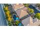 A birds eye view of a backyard pool with lounge chairs and umbrellas at 10902 Pentland Downs St, Las Vegas, NV 89141