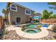 Beautiful backyard with a lagoon-style pool, spa, and desert landscaping, perfect for relaxation at 10902 Pentland Downs St, Las Vegas, NV 89141