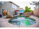 Tranquil backyard featuring a rock-accented pool and spa, offering a private outdoor retreat at 10902 Pentland Downs St, Las Vegas, NV 89141