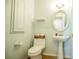 Charming half-bath features pedestal sink, decorative mirror, and light green walls at 10902 Pentland Downs St, Las Vegas, NV 89141