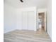 This bedroom features wood-look floors and a closet with sliding doors at 10902 Pentland Downs St, Las Vegas, NV 89141
