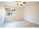 This bedroom offers a bright interior with wood-look flooring and natural light through a large window at 10902 Pentland Downs St, Las Vegas, NV 89141