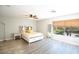 Bright bedroom with wood floors, a large window, and a bed with white furniture at 10902 Pentland Downs St, Las Vegas, NV 89141